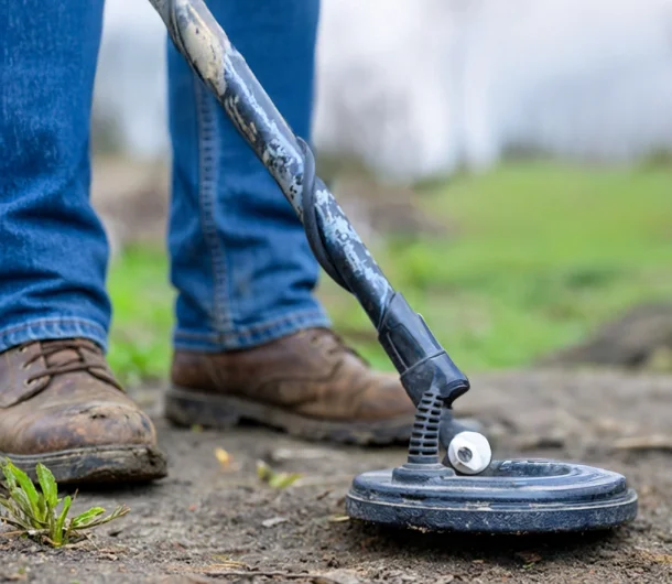 Action Septic technician using electronic locating equipment to find a buried septic tank in the Okanagan